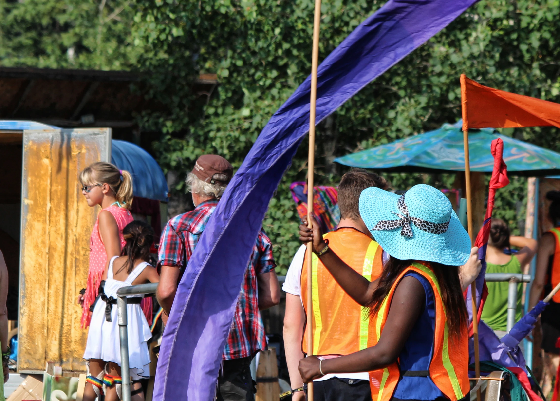 a group of people standing around with colorful flags