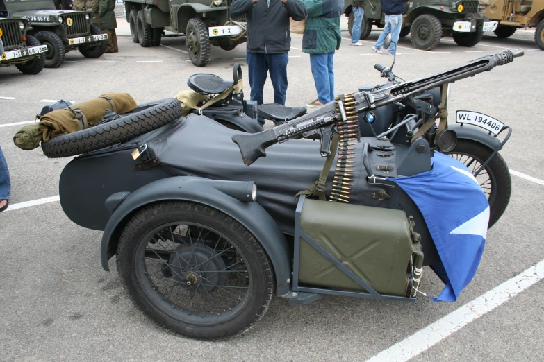 an old motorcycle with guns, guns and other accessories