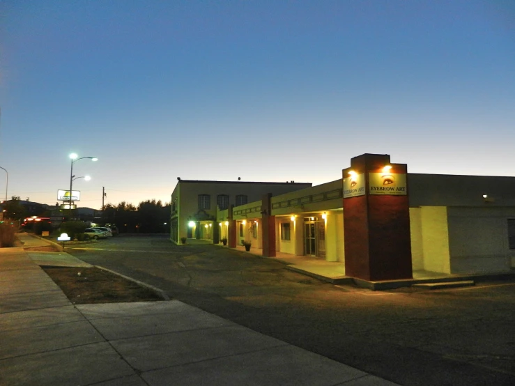 the street lights shine on a building in the evening