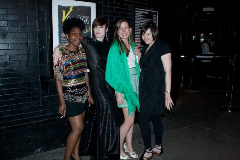 three women dressed up pose for a po