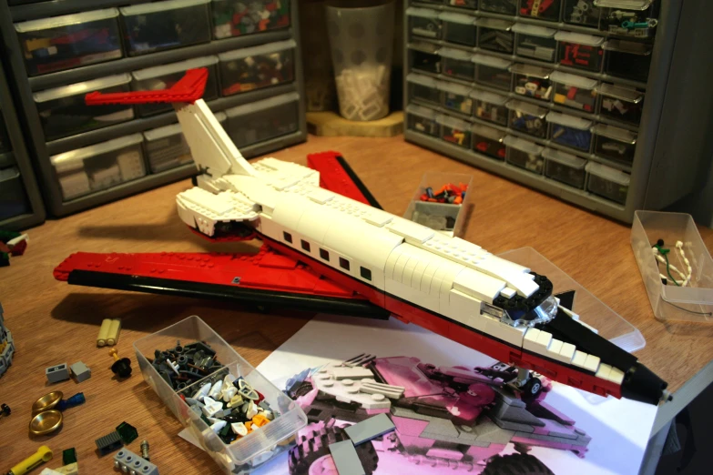 a lego model of a small white plane on a table