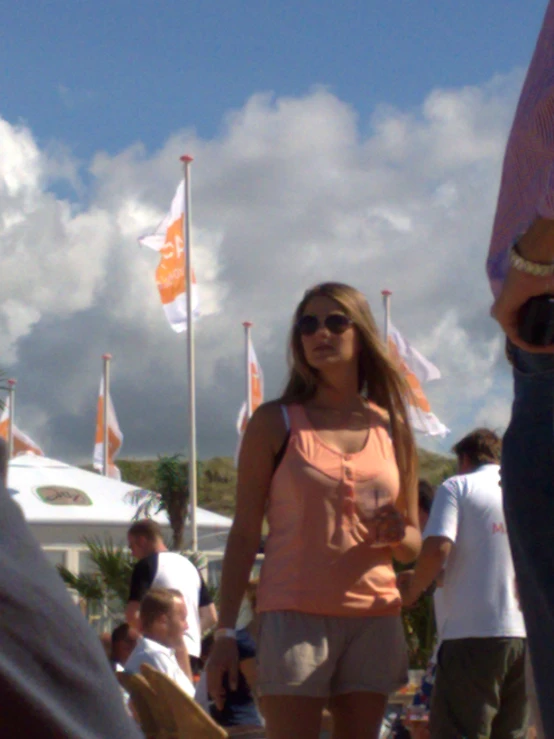 the woman stands near flags and other people