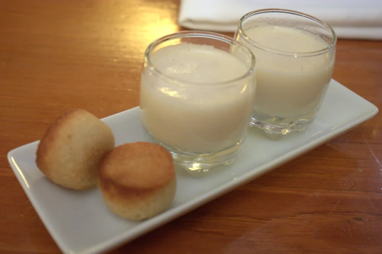 an image of a two glasses with some dessert on a table