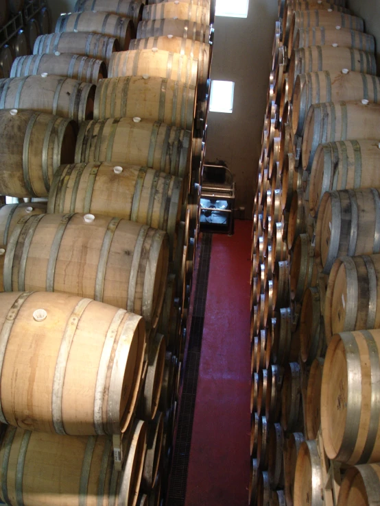 the inside of a wine cellar with multiple barrels lined up