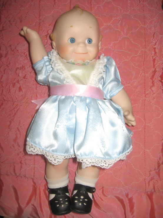 a very cute baby doll in a pretty dress