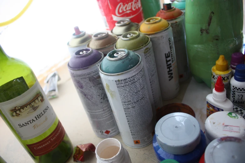 many types of cans of spray paint are lined up