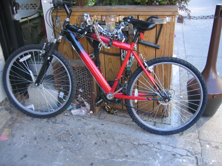 the bike is parked next to a potted plant on the sidewalk