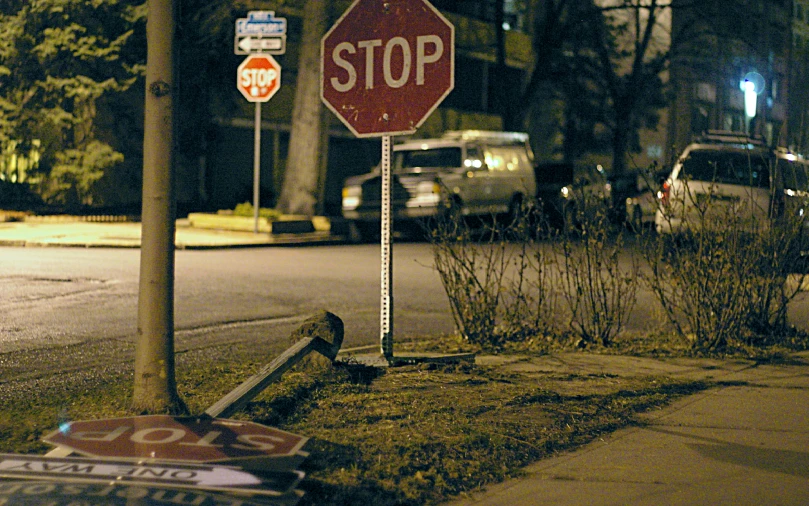 the stop sign is knocked over at an intersection
