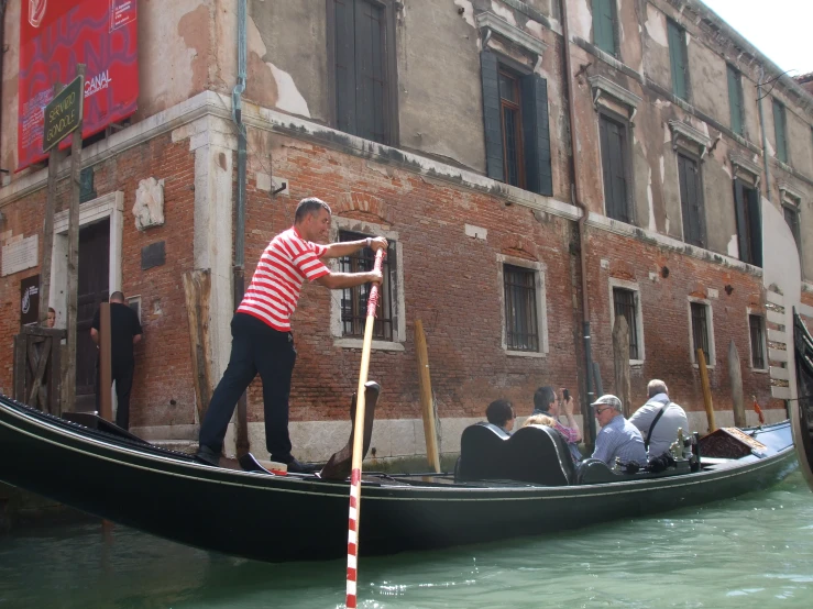 there is a man that is standing in a boat