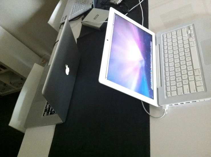 a laptop is connected to a large macbook pro