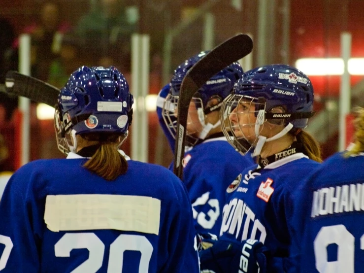 a group of hockey players standing next to each other
