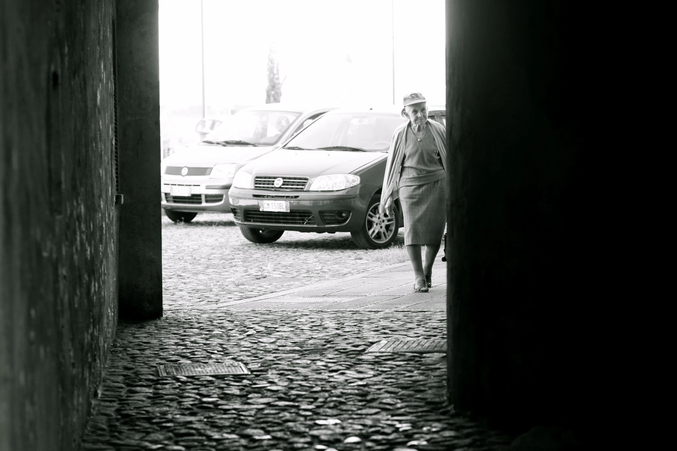 man walking through an open doorway in the city