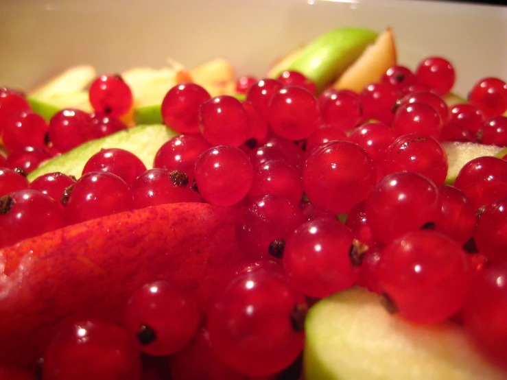 closeup of red fruits including apples, celery, and gs