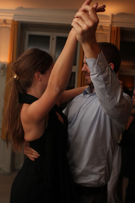 a couple dancing with each other at a dance