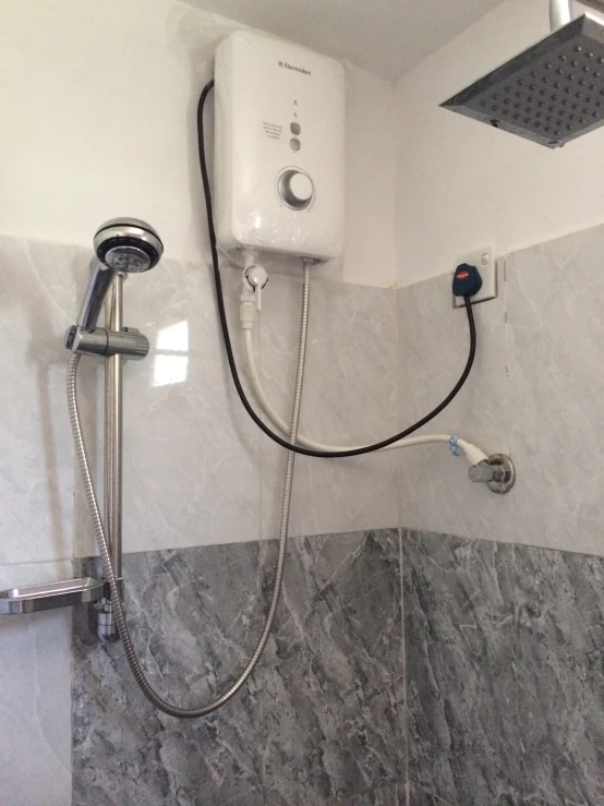 an all white shower with a black hose in it