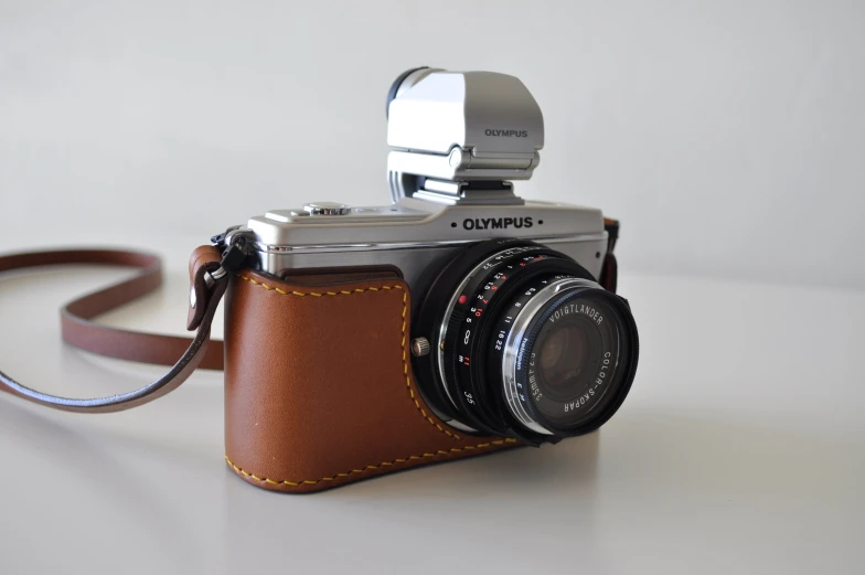 a camera has a leather case and is next to it