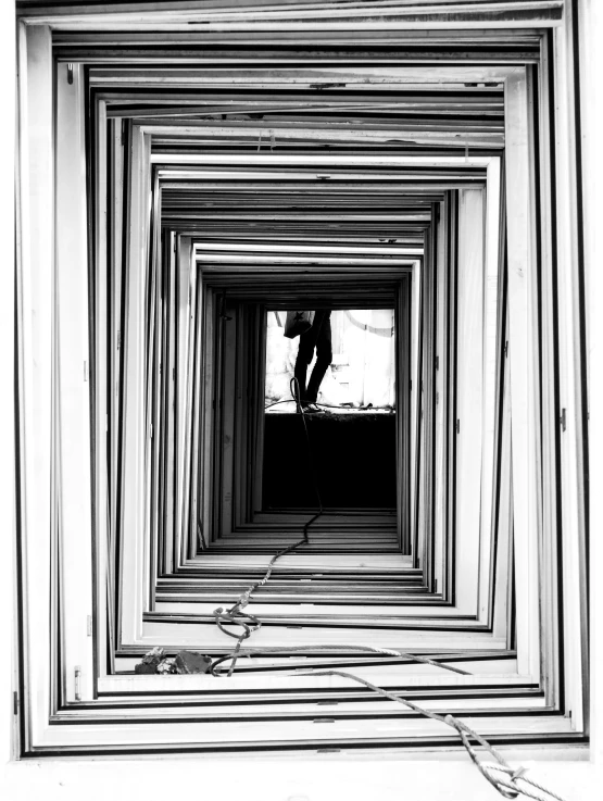 a black and white po of a man standing inside a tunnel