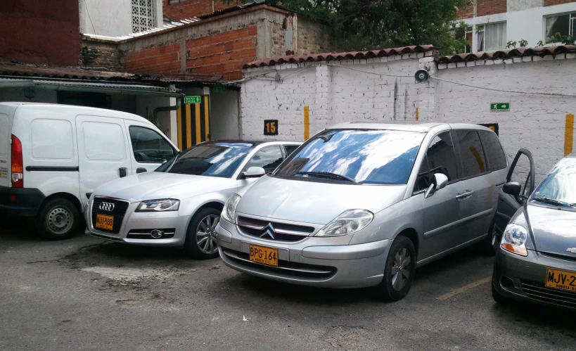 three cars parked in a parking lot next to each other