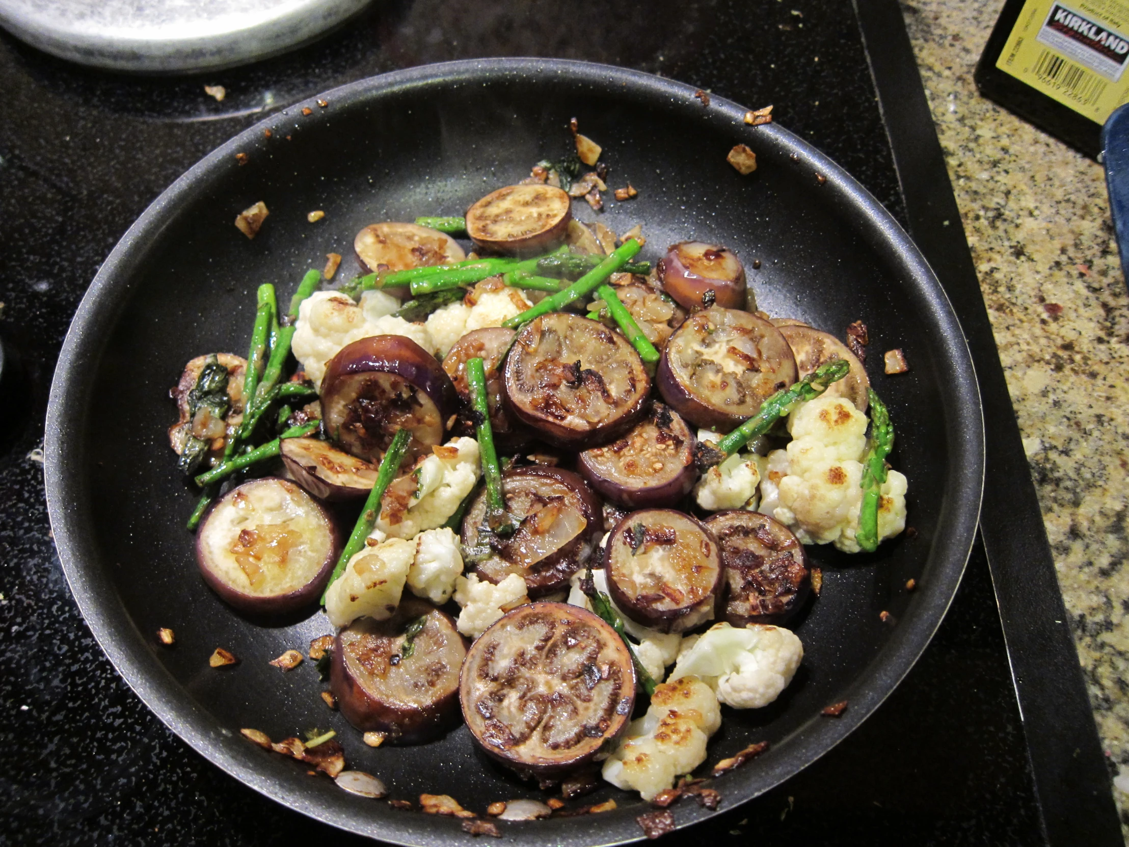 a pan with cooked vegetables on the stove