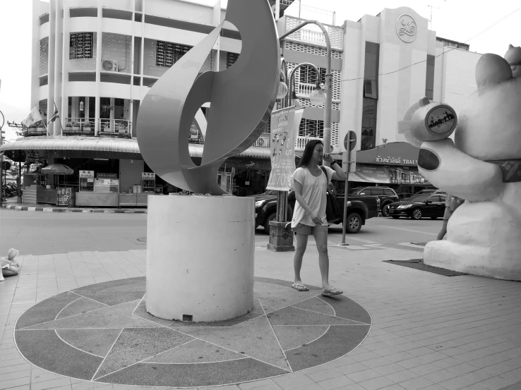 the sculpture has a person on it on the street