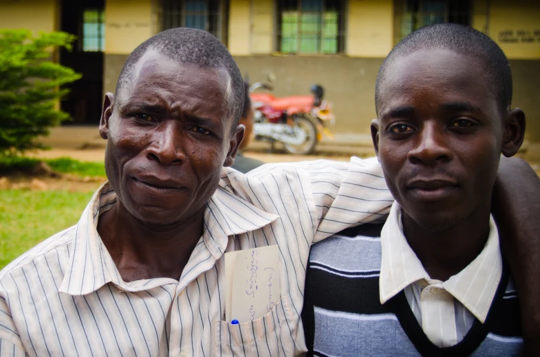 two men in front of a building posing for a po