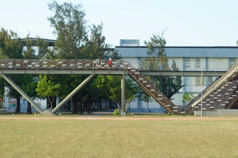 a woman walks along a wooden walkway on a bridge