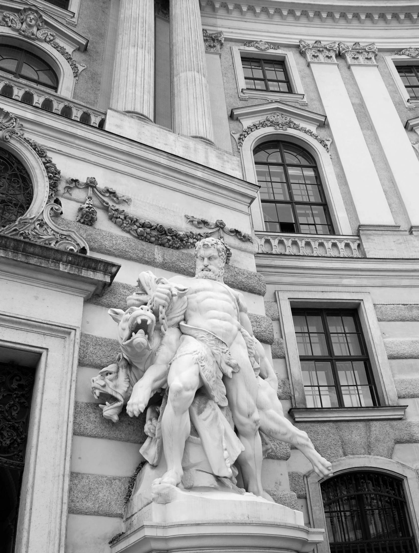 statue of a man next to an old building