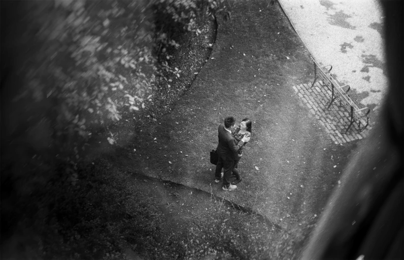 an aerial s of a man in the rain holding an umbrella