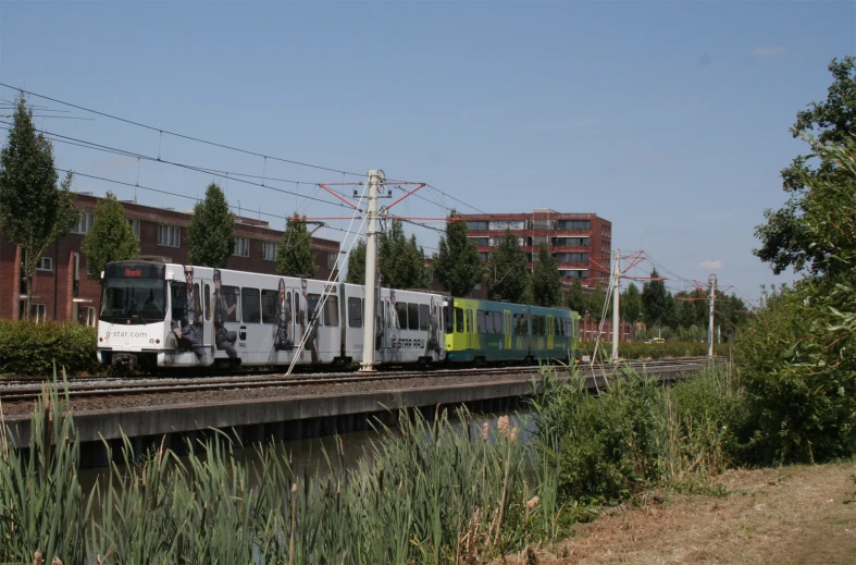 a train driving down the tracks on a sunny day