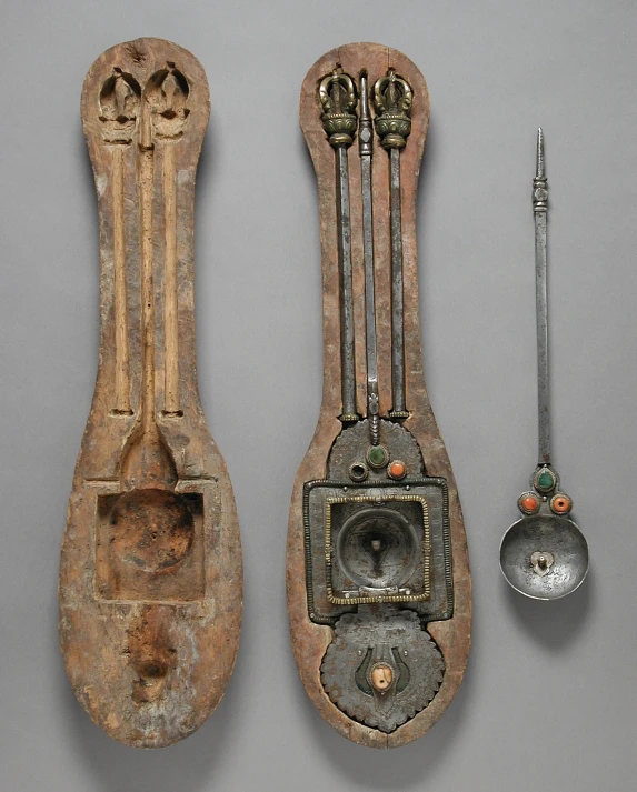 an old wooden and metal instrument with other things