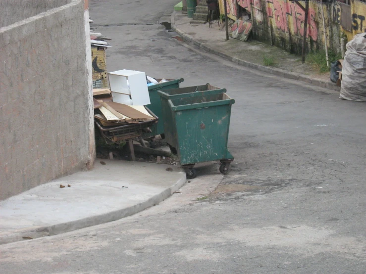 the side of the street has a green trash can