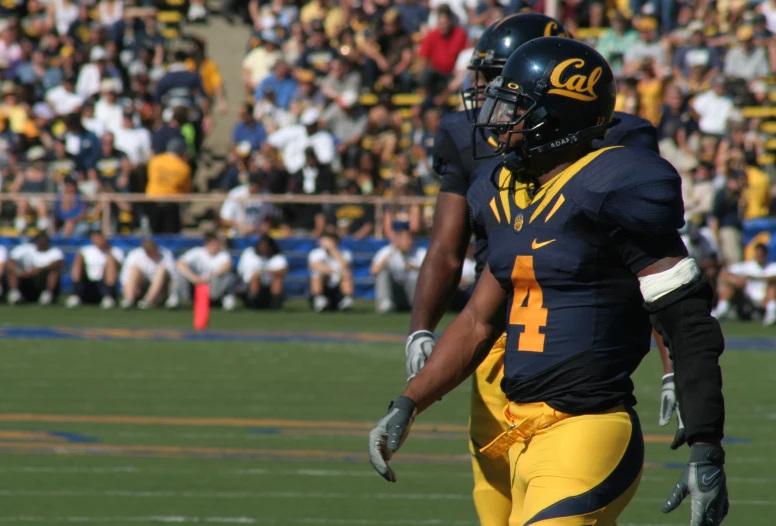 a football player walking off the field with his foot