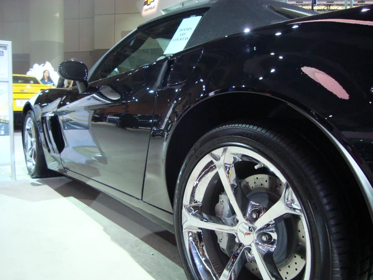 a chevrolet camaro with a shiny shiny silver wheel