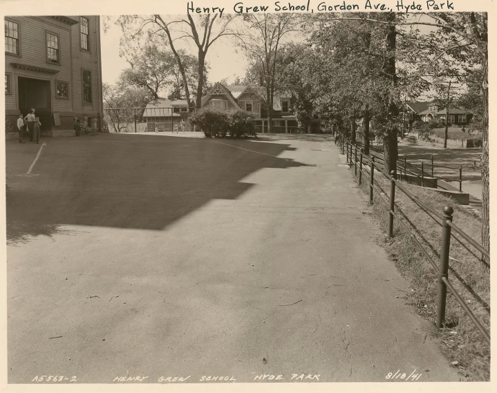 black and white pograph of driveway in front of homes