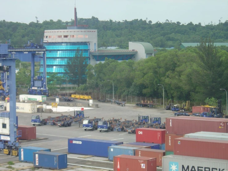 a large yard full of lots of shipping containers and cranes