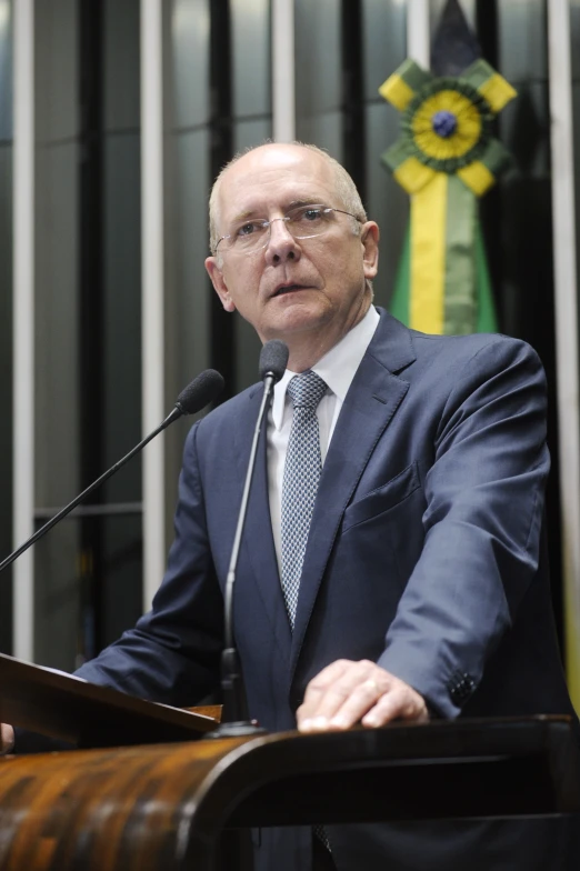 a man in a suit speaking from a podium