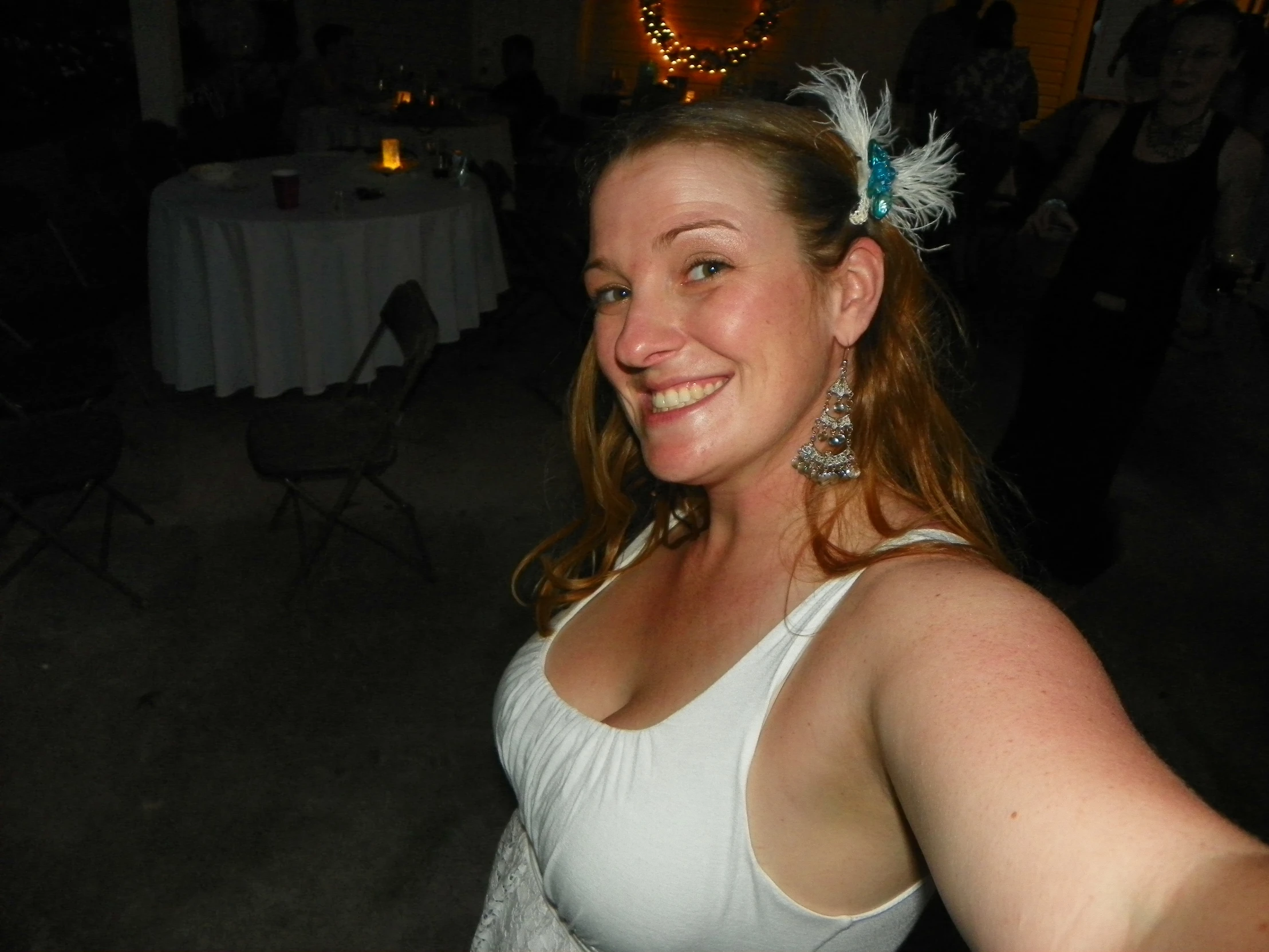 woman dressed in white standing at a reception