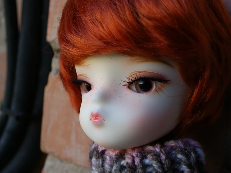 a doll is shown with bright orange hair