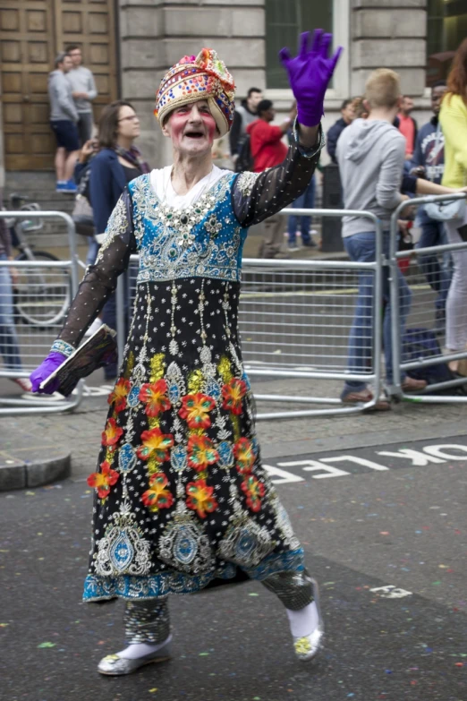 a woman dancing with hands up on the street