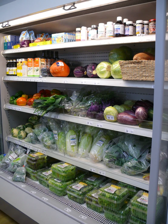 a shelf in a grocery store with fruits and vegetables