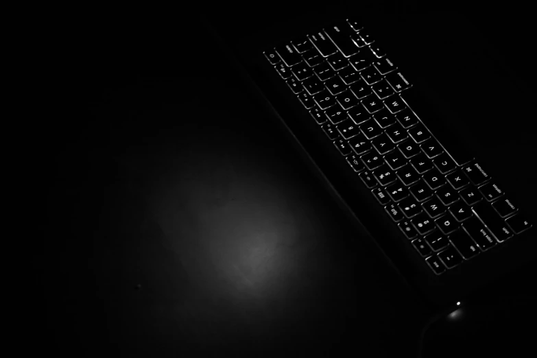 a black and white image of a keyboard in the dark