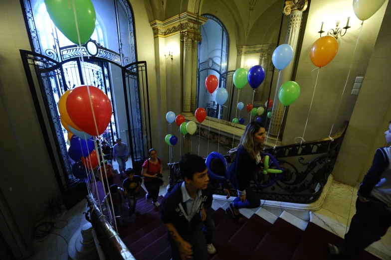 several people standing on the stairs at a party