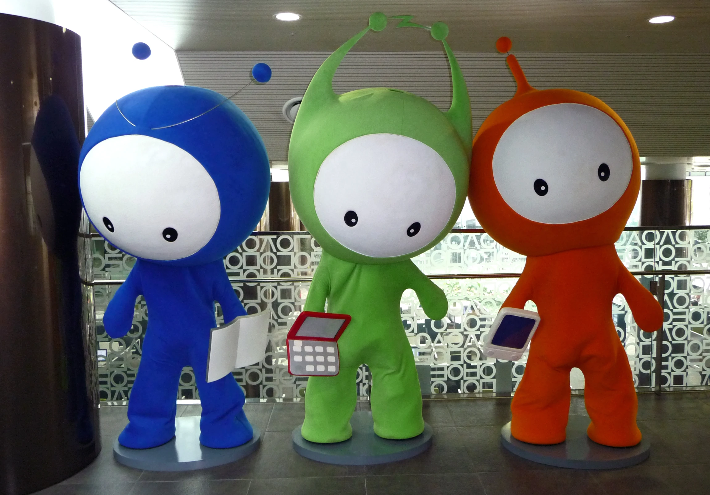 three toy character sculptures sit on a shelf