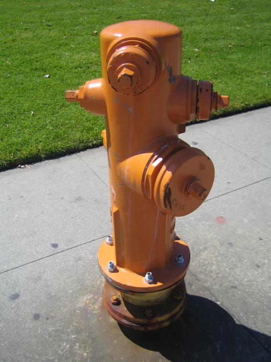 an orange fire hydrant sits on the sidewalk