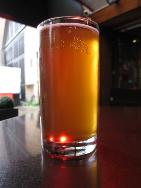 the close up of a glass on a table in a bar