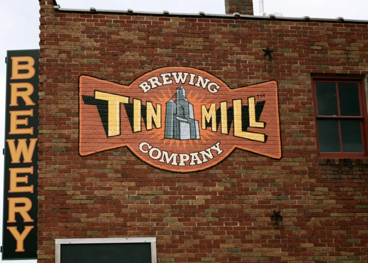 a close up of a brick building with a sign and windows