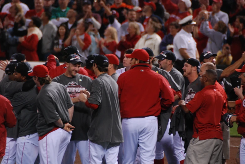 some baseball players are standing together by a crowd