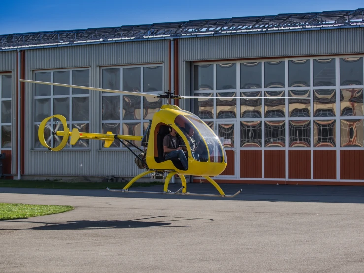 the helicopter is parked near a large building