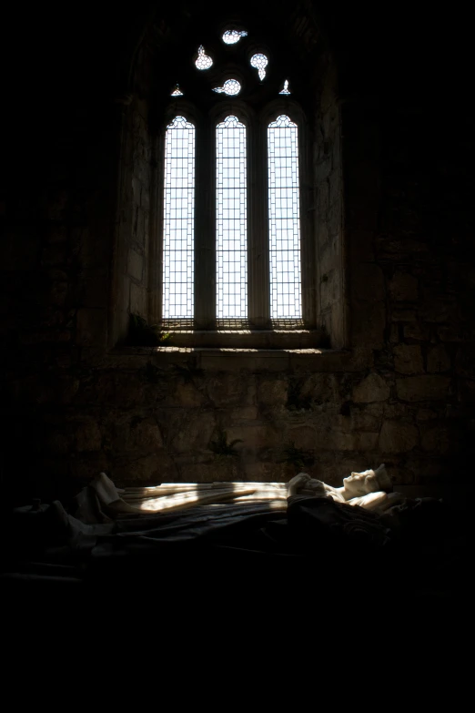 a dark room that has two stained glass windows