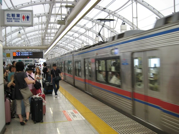 a group of people stand in front of a train